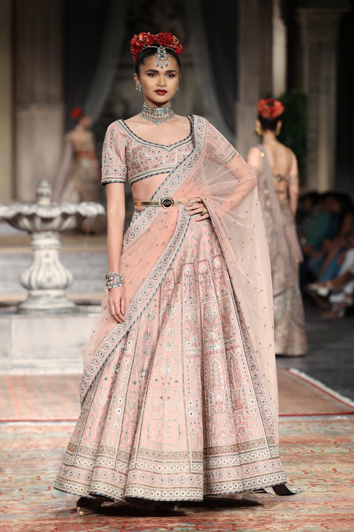 services-04 Model in traditional Indian saree walking the runway during a fashion show in New Delhi.